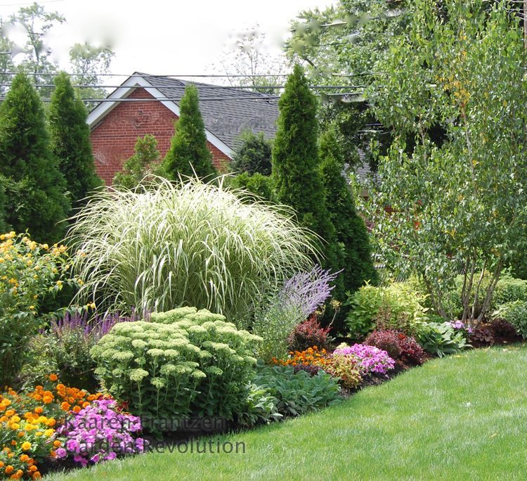 Beautiful landscaped border…privacY and beauty.  Low medium, and tall in drifts of color and texture.