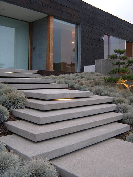 cantilevering entry steps with ornamental grass