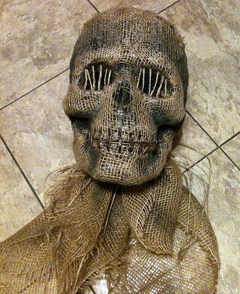 DIY creepy Halloween skull – cheap plastic or foam skull + burlap glued over it + staples and twine across mouth + twine over eye