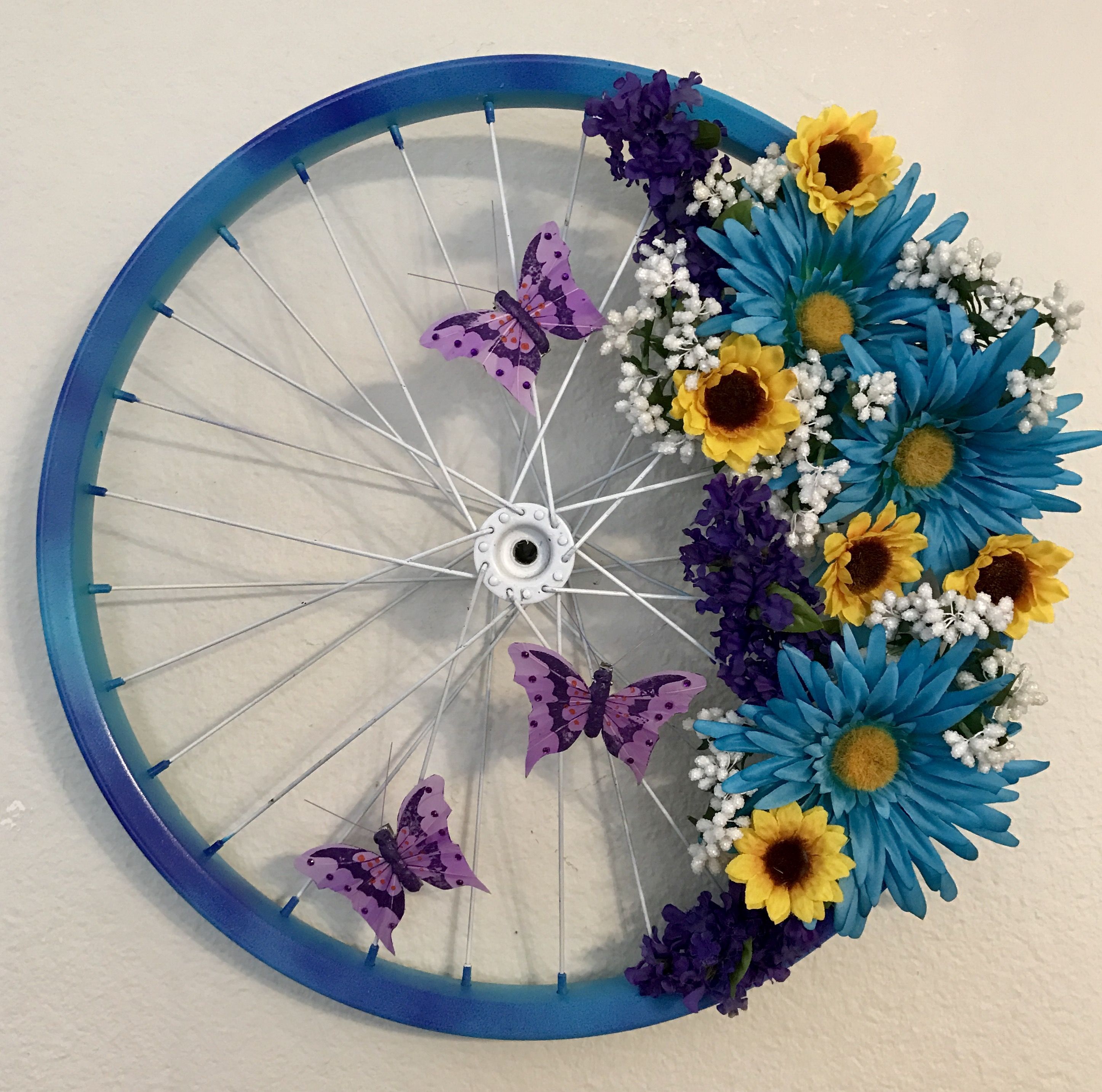 Floral butterfly bicycle wheel wreath for spring; Just Jenn Home Arts.
