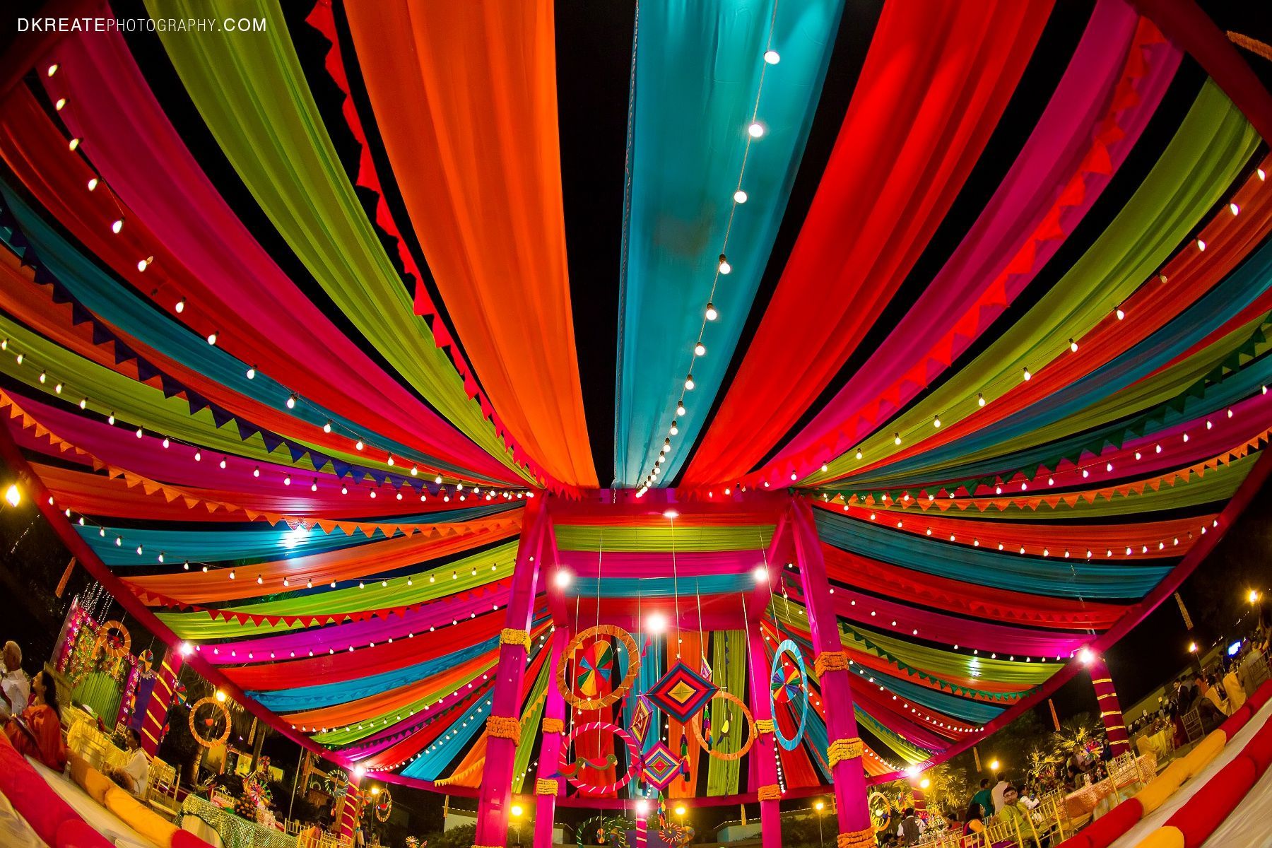 Indian wedding backdrop ideas. Colorful. Mela themed. Colorful woollen thread hanging for the wedding. Mehndi decor. Vibrant and