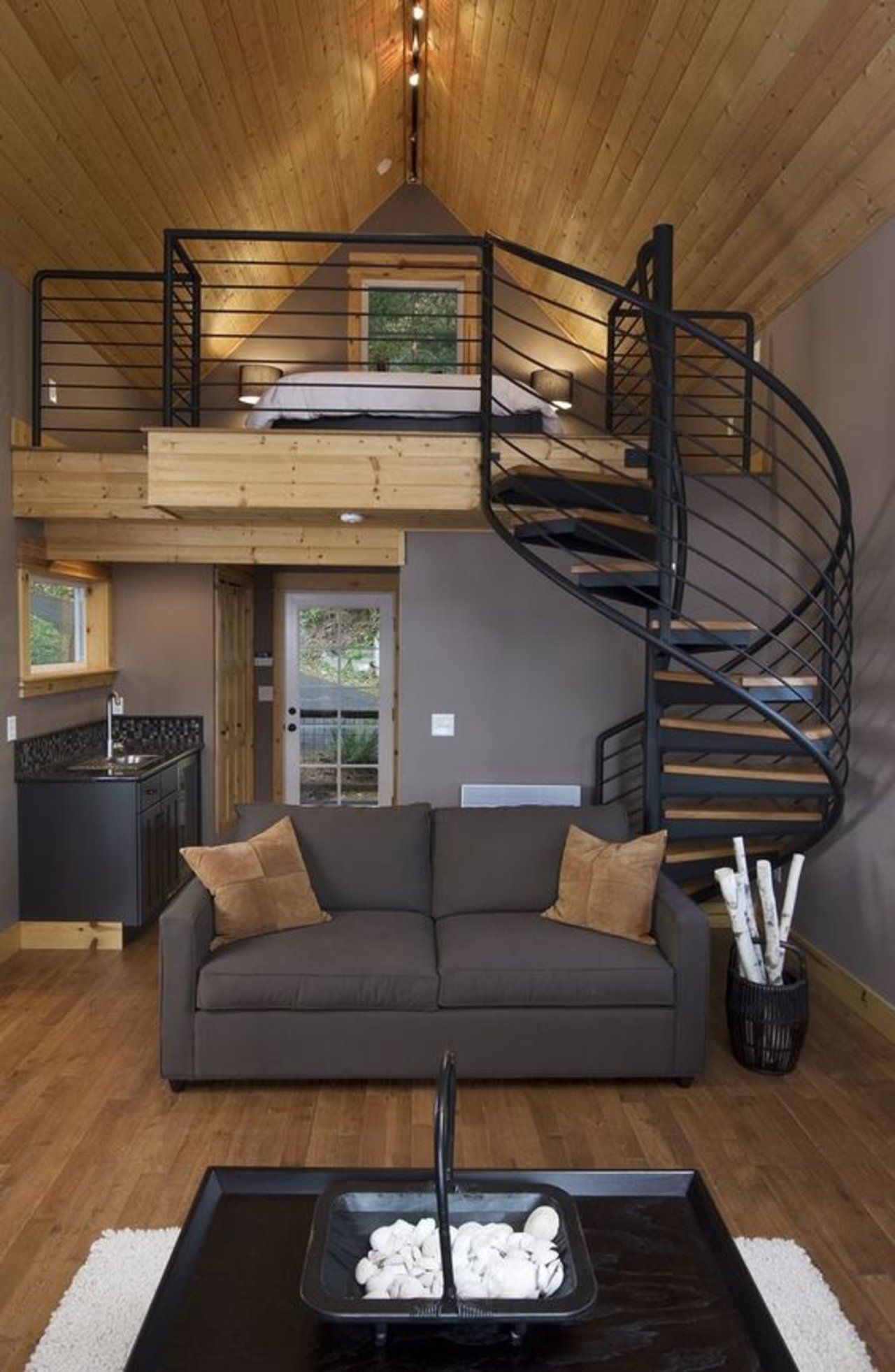 Stylish tiny house with a spiral staircase