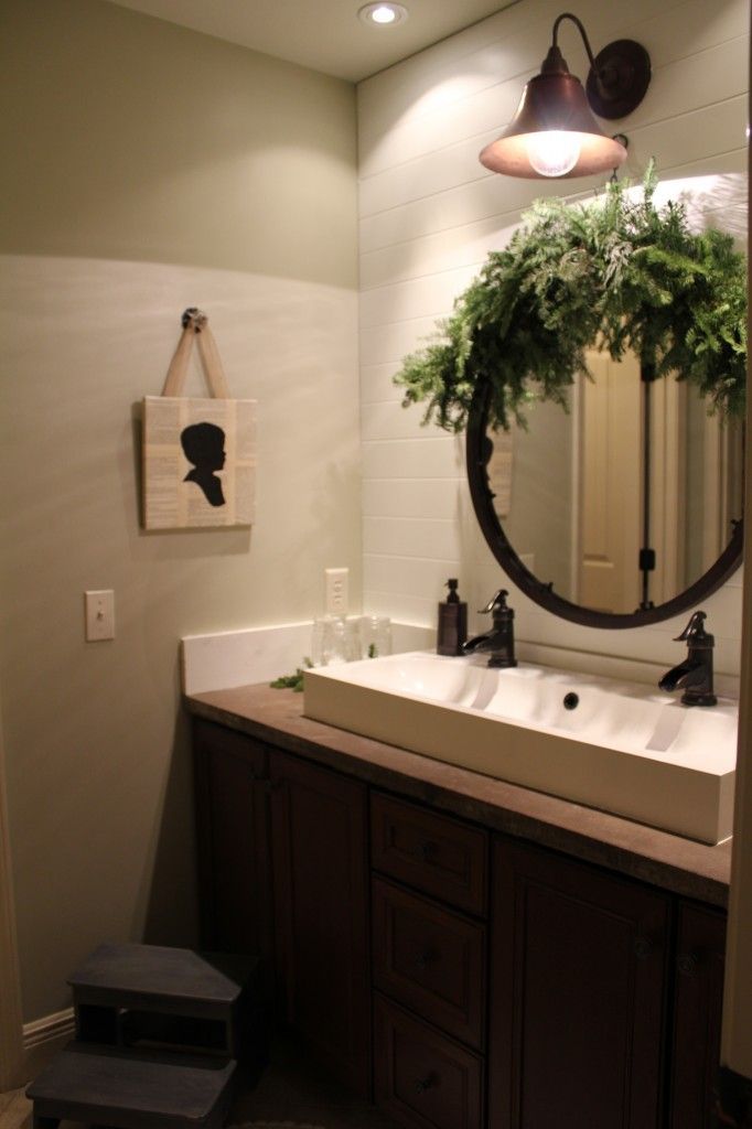 Even bathrooms can get in the holiday spirit! Add a little evergreen around the mirror and you have a classic holiday bathroom.