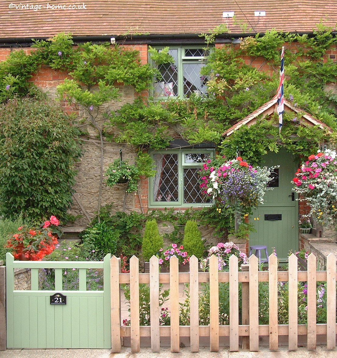English Country Garden: Pottery Cottage in Oxfordshire. The tiny front garden with hanging baskets and tubs of flowers. -   22 cottage front garden
 ideas