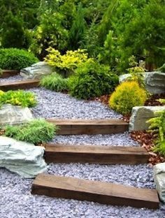 Add some visual interest and practical purpose to a sloped garden landscape by creating a gavel-stepped walkway. Pea gravel and new or salvaged wood beams are all that you will need to create one like this. Simply level out the grade, or create steps with the beams and fill in with gravel. -   22 modern garden slope ideas