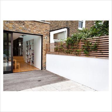 Bi fold floors leading from house to garden. Fence panel used to increase height of wall and add privacy. -   22 urban garden fence
 ideas