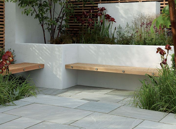 Contemporary hardwood benches built into a white rendered, walled seating/patio area Stonemarket: Garden range: Natural Stone: Trustone Fellstyle -   23 garden patio area
 ideas