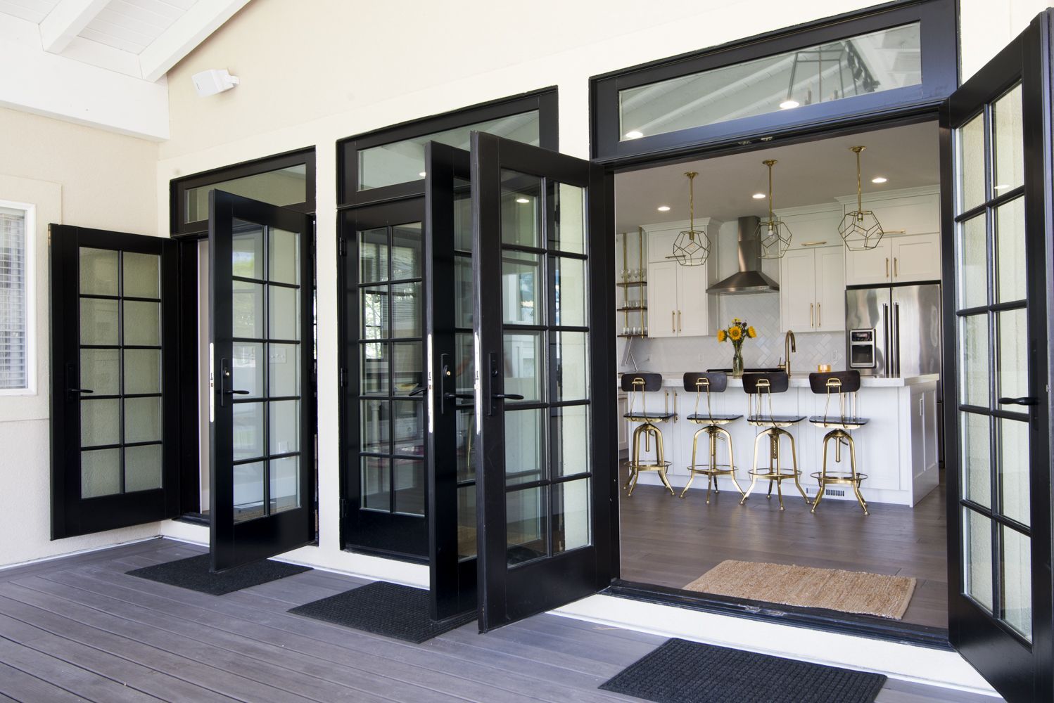 Triple french doors off the kitchen open up to let the outdoors in. Patio porch deck ideas. Home decor. black french doors -   22 patio door decor
 ideas