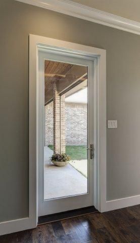 Single white fiberglass patio door with large glass view, clean trim frame the entrance. Featuring: Tuscany® Series -   22 patio door decor
 ideas