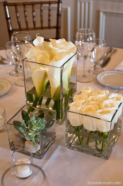 Simple and beautiful: White roses cut short and lined up in short square glass container, taller square with taller white callas and some kind of succulent in smallest square vase - modern diy decor ideas #Flowerarrangements -   23 square table decor
 ideas