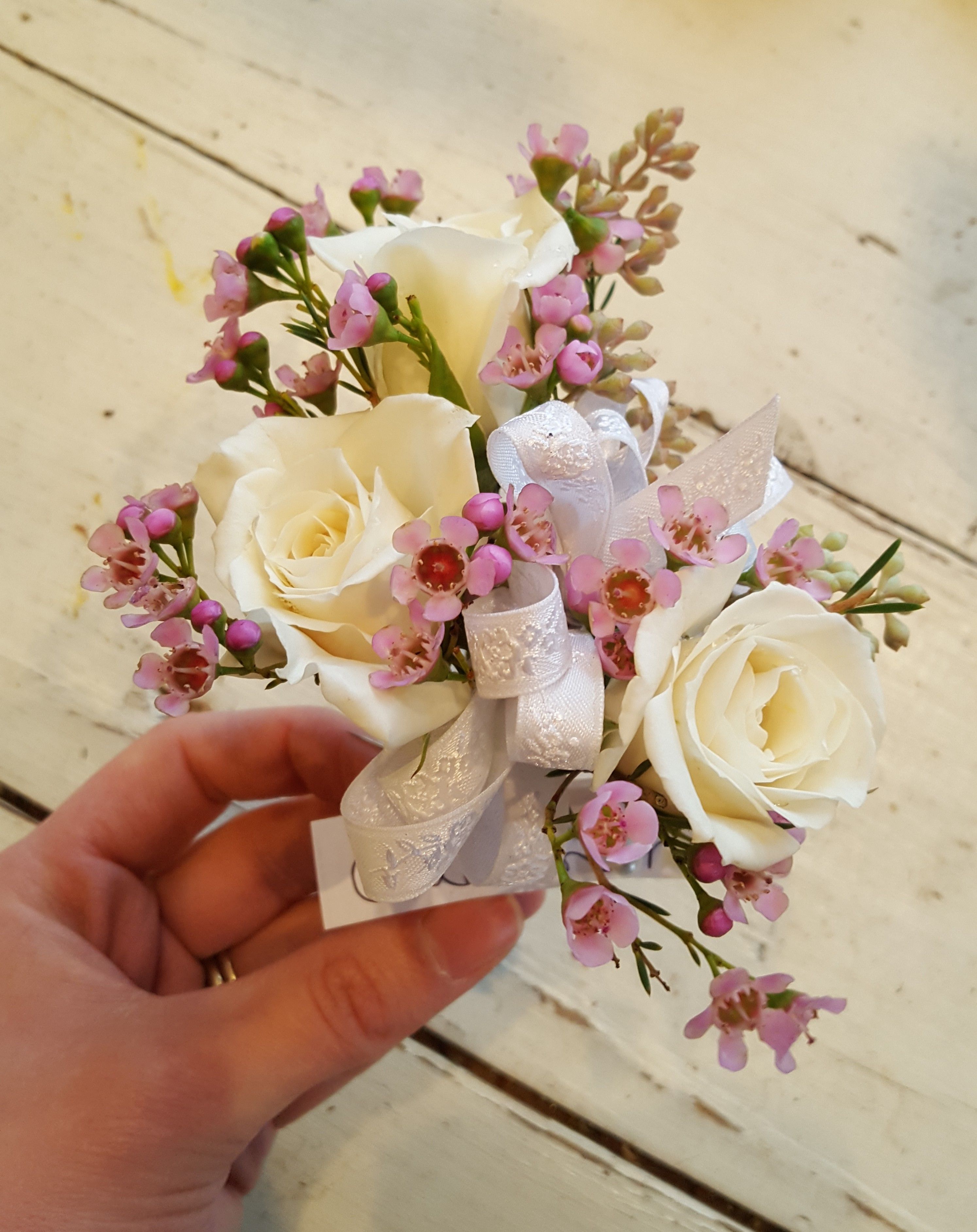 Beautiful white roses and pink wax flower corsage. Perfect for prom, wedding, and showers. -   24 diy flower corsage
 ideas