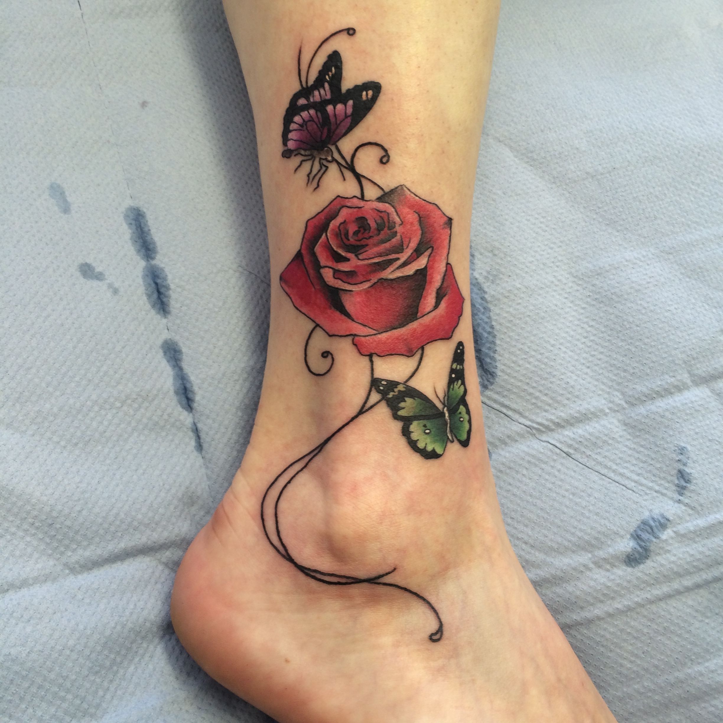 rose and butterfly ankle tattoo done by Travis Allen at twisted tattoo Yaxley Www.twistedtattoo.co.uk Or fine us on Facebook -   18 rose butterfly tattoo
 ideas