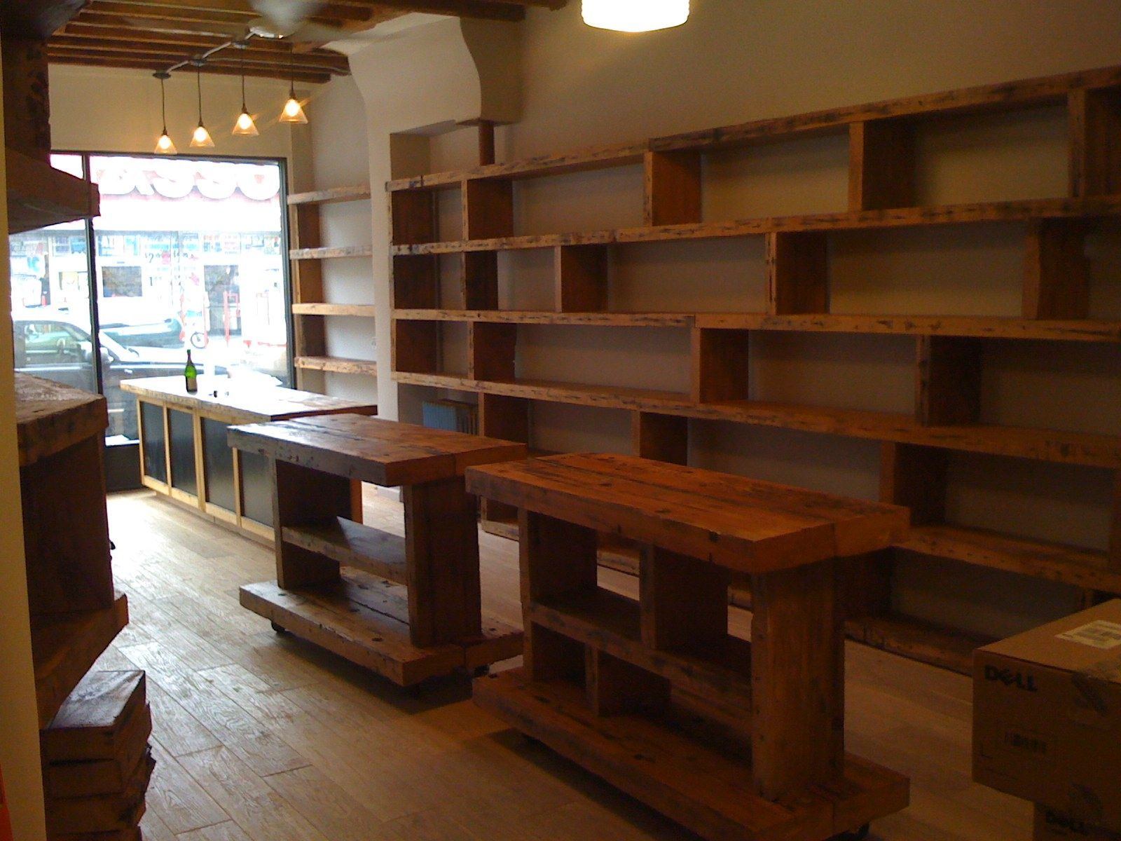 Wood shelving up the wall/pos counter reclaimed wood top -   19 shop fitness ideas