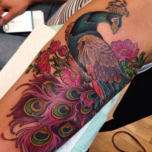 61 Beautiful Peacock Tattoo Pictures and Designs -   22 peacock thigh tattoo ideas