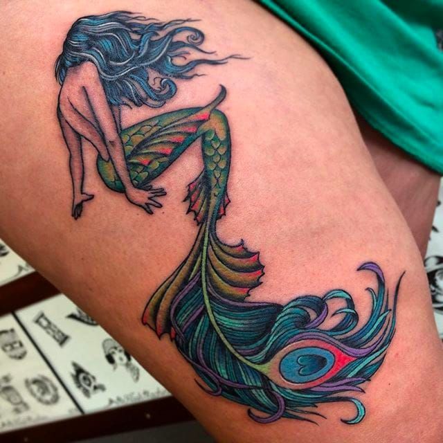Awesome mermaid with a funky looking tail! -   22 peacock thigh tattoo ideas