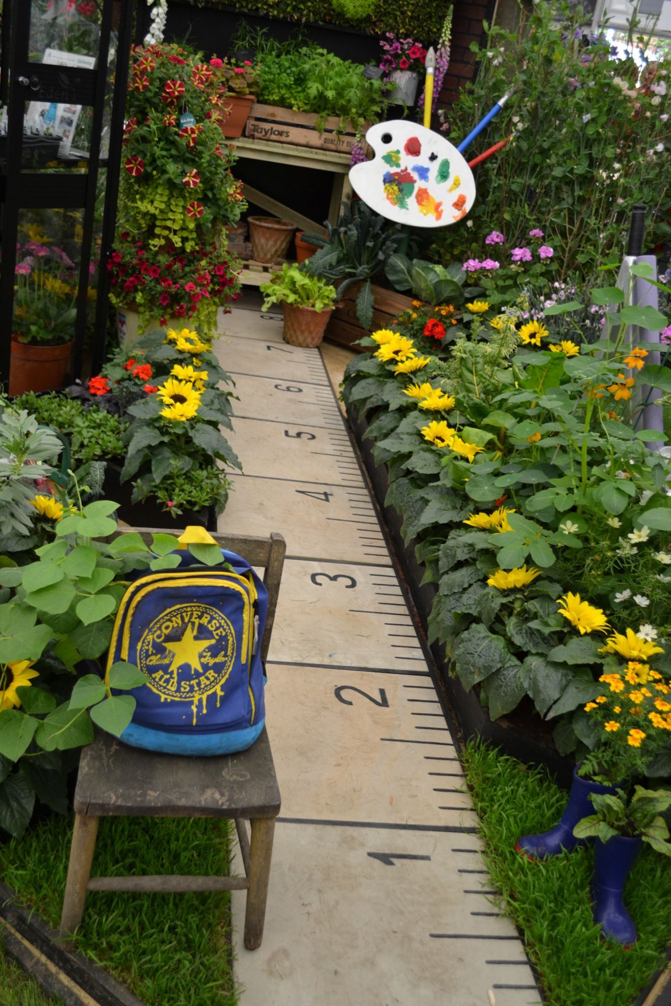 Ruler footpath lined with sunflowers ideal for kids garden or a school garden -   23 outdoor garden for kids
 ideas