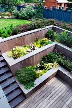 Egress landscaping  Like the modern look of tiers and steps.  Because our egress is smaller, wider first tier...smaller second tier? -   24 tiered garden decking
 ideas