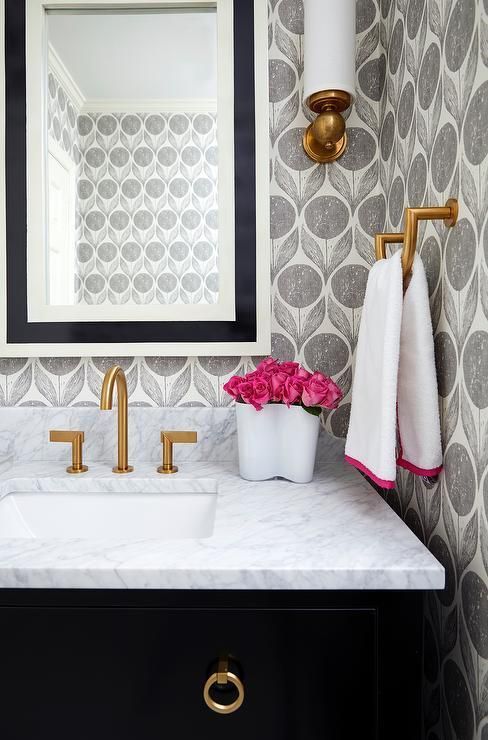 A black and white beveled mirror illuminated by an antique brass uplight sconce lines an ivory and gray floral print wallapper stands over a black sink vanity adorned with brass ring pulls topped with white quartz fitted with a white porcelain sink and brushed gold faucet. -   21 fitness wallpaper
 ideas