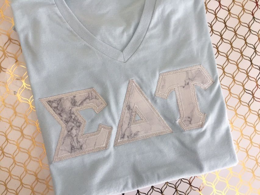 Marble V neck greek lettered shirt. Beautiful V neck greek lettered shirt with high quality fabric and stitching. These stitched letter shirts are perfect for representing your sorority. -   23 greek letter crafts
 ideas