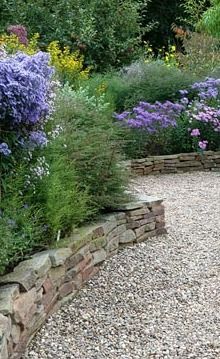 Dry stone wall forming raised borders -   24 english garden wall
 ideas